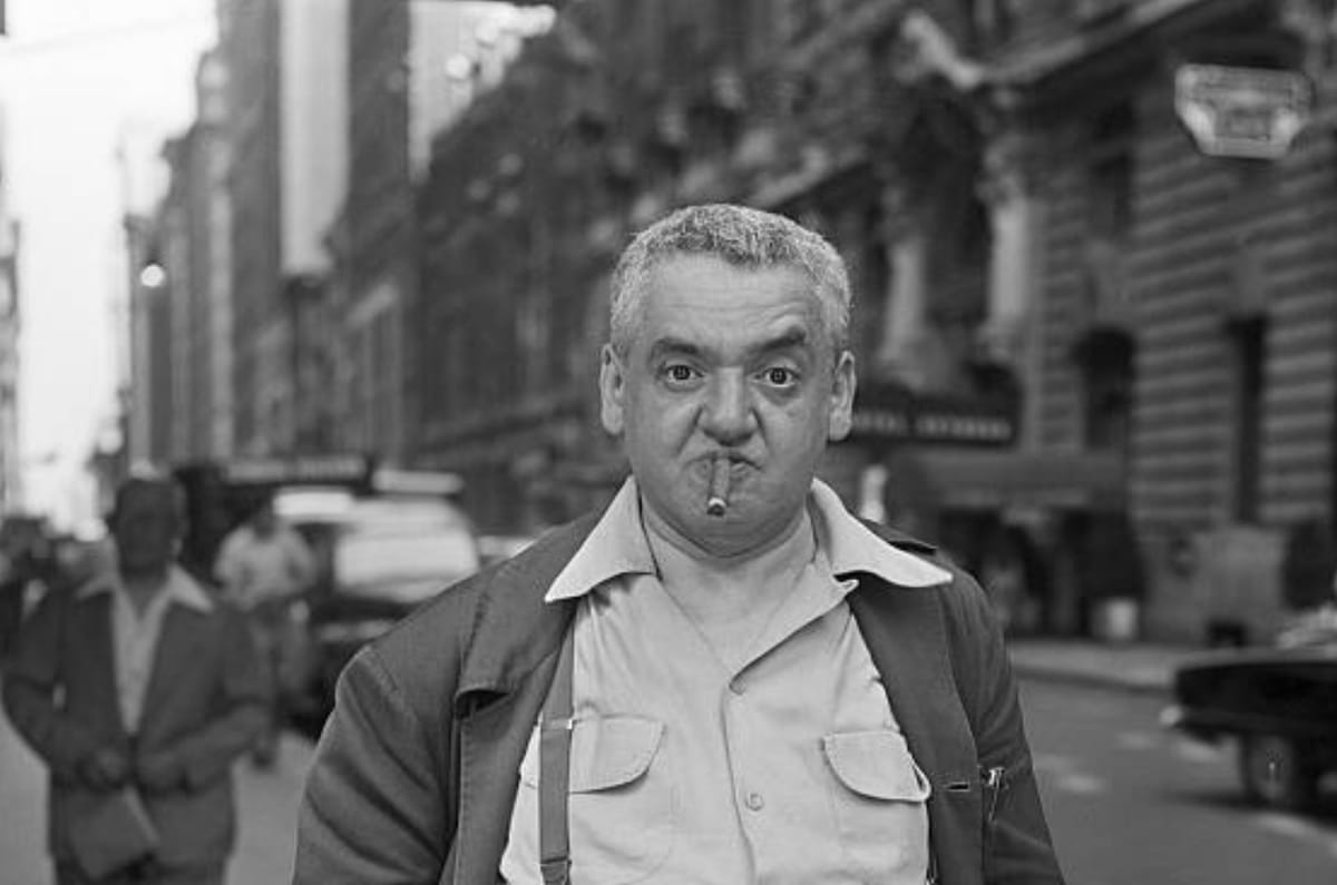 Vintage photo of the famous photographer Weegee, a stout older guy with a cigar in his mouth.