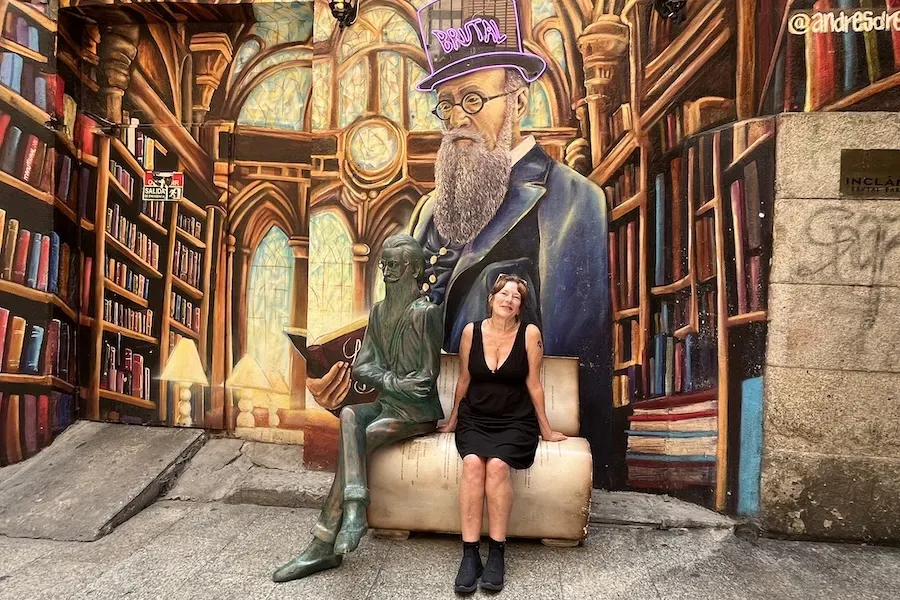 Deborah Douglas Wilbrink sits on Spanish author's lap in Madrid library-live, mural & statue.