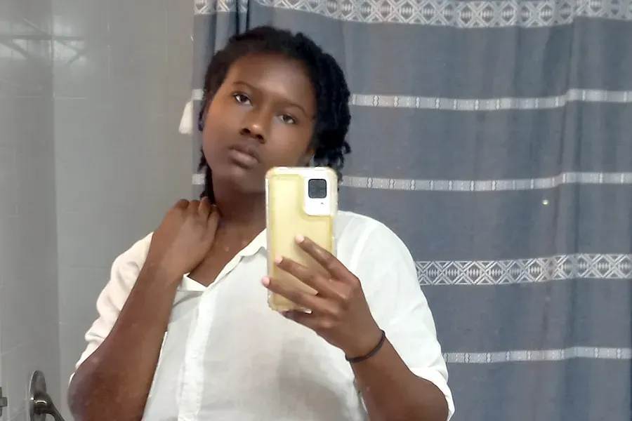 The author takes a photo of herself in the bathroom mirror.